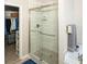 Updated shower with frameless glass enclosure and marble-look tile at 500 Chestnut Walk, Canton, GA 30114