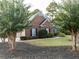 Brick house exterior with landscaping, two-car garage, and American flag at 500 Chestnut Walk, Canton, GA 30114