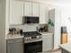 Updated kitchen with stainless steel appliances and white cabinets at 500 Chestnut Walk, Canton, GA 30114