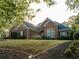 Brick home with a large front yard and mature trees at 500 Chestnut Walk, Canton, GA 30114