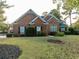 Brick home with a landscaped lawn and walkway at 500 Chestnut Walk, Canton, GA 30114