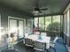Relaxing screened porch with ceiling fan and seating area at 500 Chestnut Walk, Canton, GA 30114