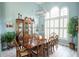 Formal dining room with large table, hardwood floors, and plant at 500 Chestnut Walk, Canton, GA 30114