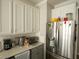 Modern kitchen with stainless steel appliances and white cabinets at 500 Chestnut Walk, Canton, GA 30114