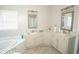 Elegant bathroom with double vanity, large mirrors, and a corner soaking tub at 500 Chestnut Walk, Canton, GA 30114