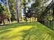 Landscaped backyard with a grassy area and fence at 2818 Willowstone Dr, Duluth, GA 30096