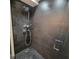 Sleek shower with dark tile walls and pebble floor at 375 Ralph Mcgill Blvd # 505, Atlanta, GA 30312