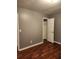 Simple bedroom with gray walls, wood-look floors, and a closet at 835 Amelia Grove Ln, Lawrenceville, GA 30045