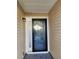 Black front door with glass inserts and sidelight at 835 Amelia Grove Ln, Lawrenceville, GA 30045