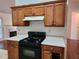 Kitchen features a gas range, built-in microwave, and wood cabinets at 835 Amelia Grove Ln, Lawrenceville, GA 30045