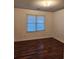 Bright bedroom featuring wood-look floors and window blinds at 835 Amelia Grove Ln, Lawrenceville, GA 30045