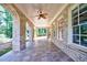 Covered patio with brick columns, tile flooring, and ceiling fan at 2770 Pebble Hill Trce, Duluth, GA 30097