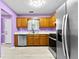 Purple kitchen with wood cabinets, stainless steel appliances, and white countertops at 12227 Cypress Ln, Fayetteville, GA 30215