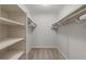 Large walk-in closet with built-in shelving and hanging rods at 1150 Collier Nw Rd # M2, Atlanta, GA 30318