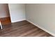 Well-lit bedroom with wood-look floors and access to hallway at 1205 Bramlett Creek Pl, Lawrenceville, GA 30045