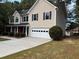 Two story house with a two car garage and manicured lawn at 1205 Bramlett Creek Pl, Lawrenceville, GA 30045