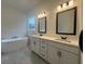 Modern bathroom featuring a soaking tub, double vanity, and tile accents at 57 Harmony Ridge Dr, Temple, GA 30179