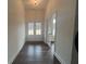 Bright entryway with dark wood-like flooring, French doors, and a view to the front yard at 57 Harmony Ridge Dr, Temple, GA 30179