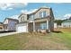 Two-story brick house with a white garage door and landscaped lawn at 7751 Plymouth Dr, Fairburn, GA 30213