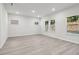 Spacious living room with light gray walls and wood-look floors at 7739 Richmond Trl, Fairburn, GA 30213