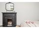 Black fireplace with ornate mantel in a bedroom at 234 E Main St, Rutledge, GA 30663