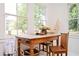 Sunroom with wooden table, chairs, and large windows at 234 E Main St, Rutledge, GA 30663