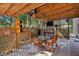 Relaxing covered patio with wooden furniture and decorative accents at 7820 Wynfield Cir, Cumming, GA 30040