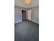 Bedroom with grey walls, carpet, and a closet at 6325 Phillips Creek Dr, Lithonia, GA 30058