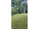 Grass backyard with some trees and shrubs at 6325 Phillips Creek Dr, Lithonia, GA 30058