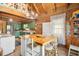 Rustic kitchen with green cabinets, a wooden island, and wood ceiling beams at 7790 Atlanta Newnan Rd, Chattahoochee Hills, GA 30268