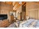 Rustic bedroom with wood walls, large bed, and antique furniture at 7790 Atlanta Newnan Rd, Chattahoochee Hills, GA 30268