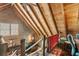 Open loft overlooking living area, with wood beams and windows at 7790 Atlanta Newnan Rd, Chattahoochee Hills, GA 30268