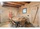 Rustic wooden dining table with six chairs in a wood paneled room at 7790 Atlanta Newnan Rd, Chattahoochee Hills, GA 30268