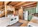Rustic kitchen with exposed beams, stainless steel appliances, and farmhouse charm at 7790 Atlanta Newnan Rd, Chattahoochee Hills, GA 30268