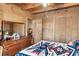 Cozy bedroom with wood walls, a dresser, and a comfortable bed at 7790 Atlanta Newnan Rd, Chattahoochee Hills, GA 30268