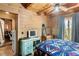 Rustic bedroom with wood walls and a view at 7790 Atlanta Newnan Rd, Chattahoochee Hills, GA 30268