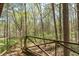 Wooden deck overlooking a lush forest at 7790 Atlanta Newnan Rd, Chattahoochee Hills, GA 30268
