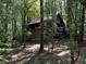 Secluded log cabin nestled in a lush forest setting at 7790 Atlanta Newnan Rd, Chattahoochee Hills, GA 30268
