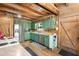 Rustic kitchen with exposed beams, stainless steel appliances, and farmhouse charm at 7790 Atlanta Newnan Rd, Chattahoochee Hills, GA 30268