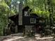 Log cabin with stone accents, deck, and private wooded lot at 7790 Atlanta Newnan Rd, Chattahoochee Hills, GA 30268