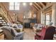 Rustic living room with a stone fireplace and wooden ceiling beams at 7790 Atlanta Newnan Rd, Chattahoochee Hills, GA 30268