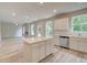 Open concept kitchen with island, stainless steel appliances, and white cabinets at 1097 Bodega Loop, Locust Grove, GA 30248