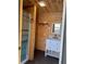 Small bathroom with wood walls and white vanity at 115 Parson Ave, Bowdon, GA 30108