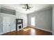 Bright bedroom with hardwood floors, fireplace, and ceiling fan at 115 Parson Ave, Bowdon, GA 30108