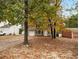 Two-story house with a green exterior, surrounded by fall trees at 3742 Linecrest Rd, Ellenwood, GA 30294