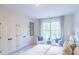 Spacious bedroom with large window and double doors at 2004 Fontainbleau Dr, Conyers, GA 30094
