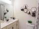 Modern bathroom with stylish hexagon shelves and a vanity with quartz countertop at 2004 Fontainbleau Dr, Conyers, GA 30094