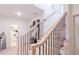 Elegant staircase with wrought iron balusters and light wood handrail at 2004 Fontainbleau Dr, Conyers, GA 30094