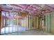 Unfinished basement with framed walls and pink insulation at 2004 Fontainbleau Dr, Conyers, GA 30094
