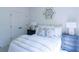 Bright bedroom with white bedding, blue nightstands, and a large window at 2004 Fontainbleau Dr, Conyers, GA 30094